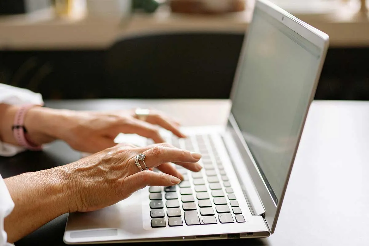 A close-up of a professional advisor performing a detailed pension review with documents